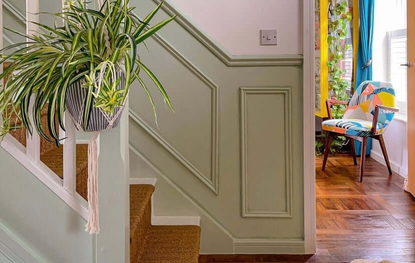 Traditional wall panelling up the stairs, painted pale green 