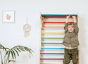 Toddler climbing Swedish ladder