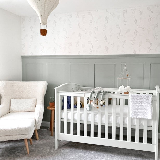 nursery with wall panels and wallpaper